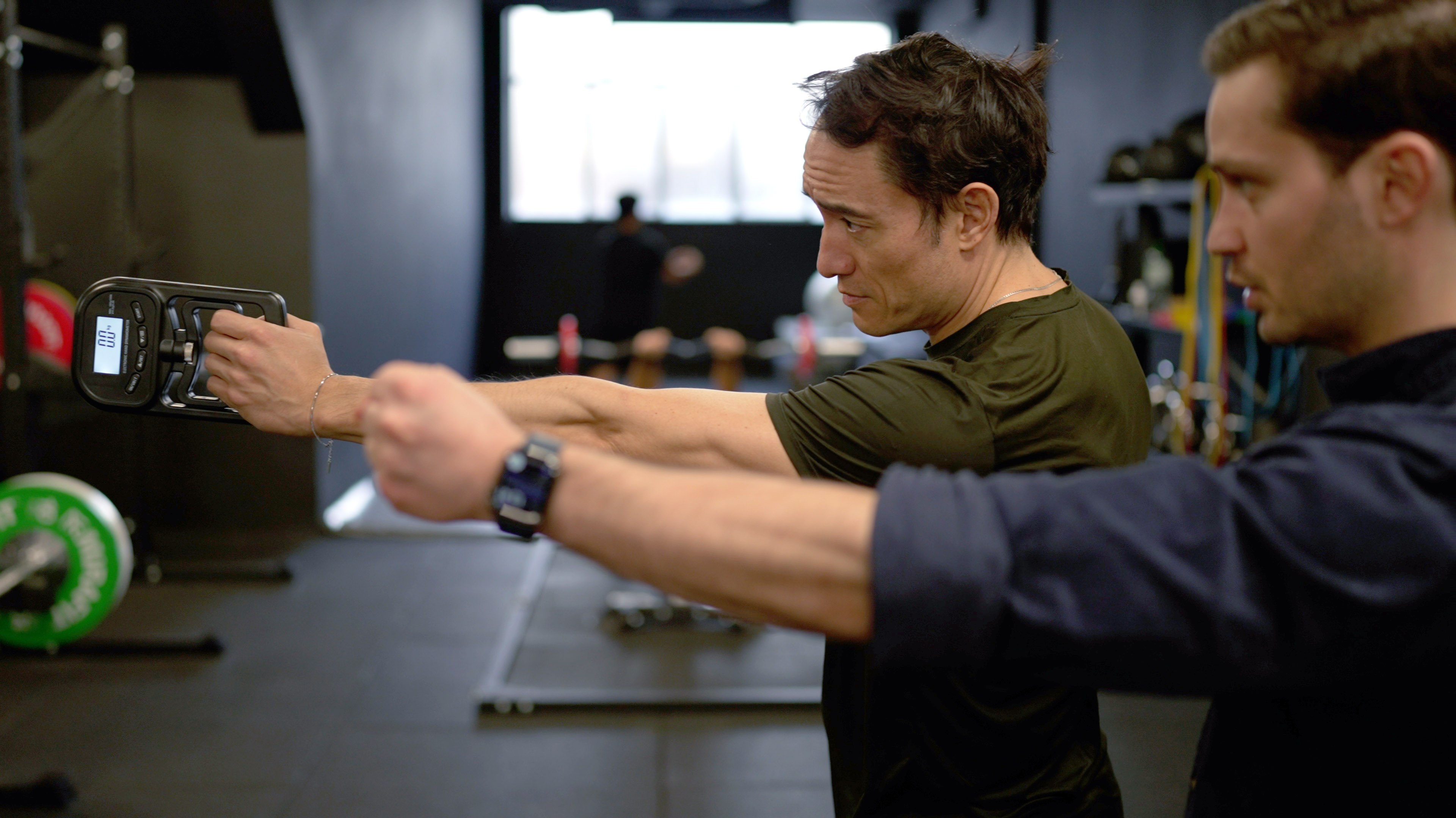 Alex Barmpas measuring grip strength with a dynamometer
